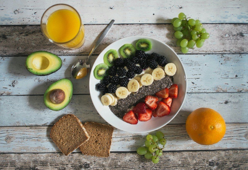 Assortment of mineral-rich foods for gut health including leafy greens, pumpkin seeds, avocado and nuts